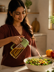 Woman using GOMANBY Oil Sprayer Bottle in a warm modern kitchen